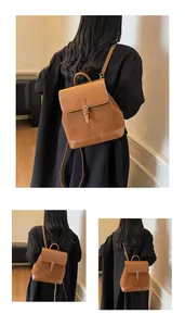 Detail of vintage brown suede and leather backpack with metal buckle and adjustable straps