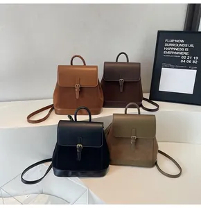 Detail of four retro flap backpacks in brown, black, coffee and olive green colors