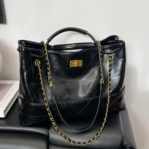 Vintage black quilted leather tote bag with gold chain strap and turn-lock closure