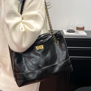 Retro black quilted leather tote bag with gold chain strap and turn-lock closure