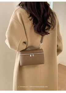 Deep brown textured leather box bag styled with a minimalist camel wool coat for women