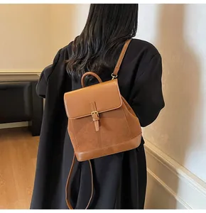 Detailed side view of the brown retro backpack featuring textured faux leather and suede
