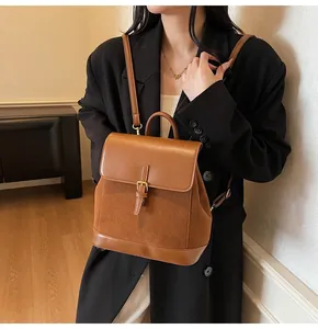 Detailed view of brown suede and leather patchwork backpack on model for daily commuting