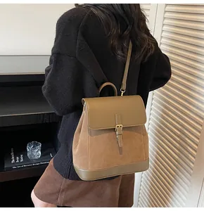 Detail of khaki suede and leather backpack with flap buckle and top handle back view