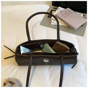 Detailed interior view of dark brown quilted tote bag showing large capacity and pockets