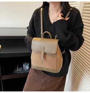 Detailed view of the vintage suede brown backpack with leather straps on a female model
