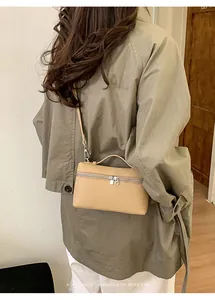 Detail of light brown leather rectangle lunch box bag with top handle and double zippers