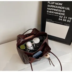 Top view of large brown tote bag showing internal storage with wallet and essentials