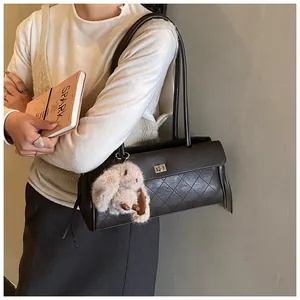 Detail of vintage quilted leather tote bag with metallic turn-lock and rabbit charm
