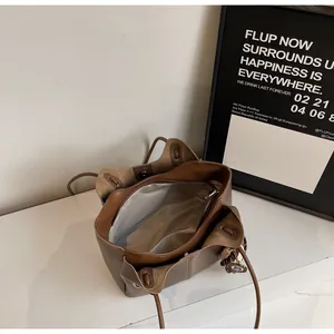 Top view of large brown tote bag interior featuring fabric lining and zipper compartment