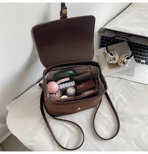 Interior view of brown suede backpack showing spacious compartments and daily essentials