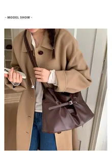 Deep brown pleated leather tote bag styled with a wool coat for a chic daily look