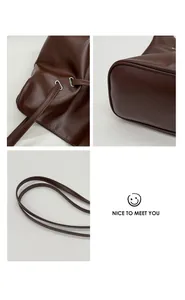 Detail of dark brown tote bag showing silver eyelets and high-quality stitching on straps