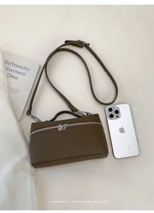 Top view of dark brown litchi pattern leather handbag with silver zipper and shoulder strap