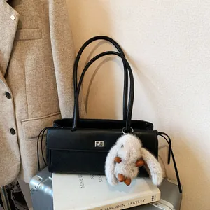 Retro black quilted shoulder bag with silver lock and a cute white bunny pendant