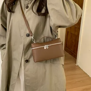 Caramel brown pebbled leather box handbag with top handle and crossbody strap