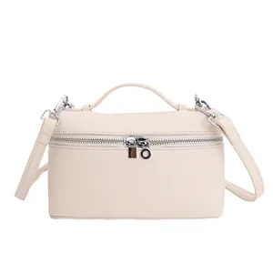 Minimalist beige pebble leather lunchbox style crossbody bag with silver hardware