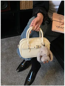 Creamy white square handbag with litchi texture and cute plush bunny charm detail