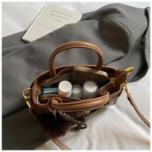 Top view of brown leather bucket bag showing interior space for daily essentials and phone