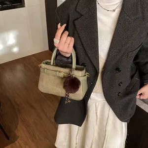 Vintage retro bucket bag in green leather and khaki fabric with plush ball charm detail