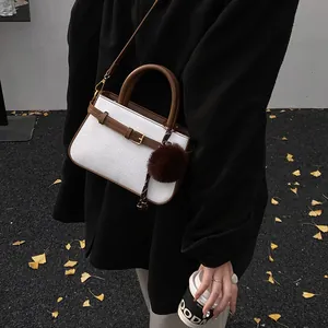 Vintage contrast bucket bag in white texture with brown leather trim and fur charm