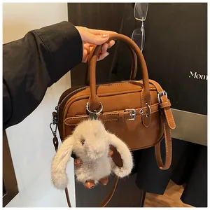 Brown litchi grain square bag featuring a top handle and a cute grey bunny plush charm
