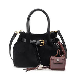 Vintage black faux suede bucket bag with leather strap and mini brown pouch charm