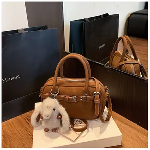 Brown litchi grain handbag featuring a silver buckle and a cute white plush bunny charm