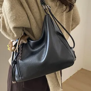 Vintage black leather Hobo bag with star and bear charms for versatile casual commuting