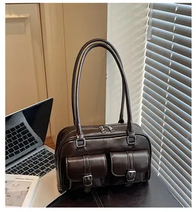 Detail of vintage coffee leather shoulder bag with double front flap pockets and buckles