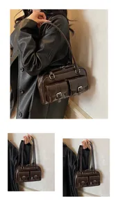 Detail of dark brown retro shoulder bag with double front utility pockets and silver buckles