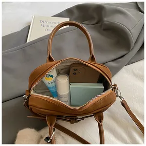 Interior view of brown lychee texture bag showing capacity for phone and cosmetics