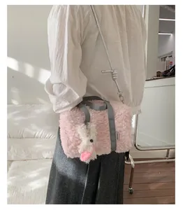 Detailed macro view of pink plush pillow bag with a cute white bunny pendant charm