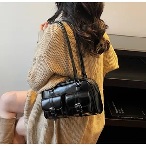 Lifestyle shot showing the black retro bowling shoulder bag with two front pockets