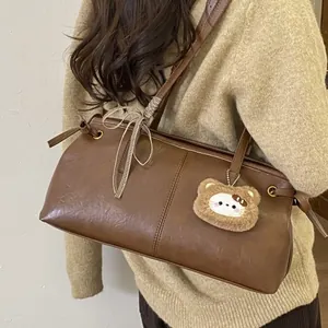 Vintage dark brown faux leather shoulder bag with a teddy bear charm and plaid bow accent