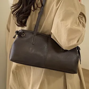 Retro dark brown leather shoulder bag for women with minimalist commuter aesthetic