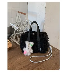Detail view of black faux fur square handbag with silver rope strap and cute rabbit charm