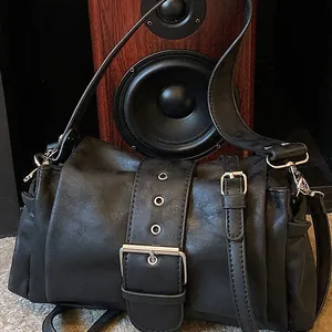 Chic black baguette shoulder bag with silver eyelets and side pleated pockets for women