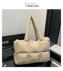 Λεπτομέρεια χακί καπιτονέ τσάντας puffer με φαρδιά λουριά για καθημερινή χρήση