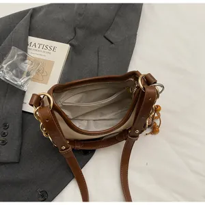 Detailed interior of the chain flap bag showing fabric lining, pocket, and golden zipper