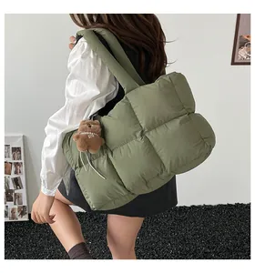 Λεπτομερής λήψη λαδί καπιτονέ τσάντας puffer με καφέ λούτρινο αρκουδάκι κρεμαστό