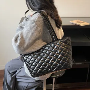 Chic black quilted puffer tote bag with glossy finish and large capacity for daily commute