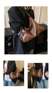 Vue détaillée du grand sac cabas marron en similicuir avec un charm teckel et mannequin