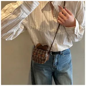 Detailed view of mini plaid crossbody bag featuring 3D flowers and a large silk bow