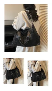 Close-up of black leopard pattern travel bag with side zipper pocket and shoulder strap