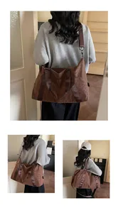 Detail view of large leopard print tote bag with brown canvas strap and metal buckles