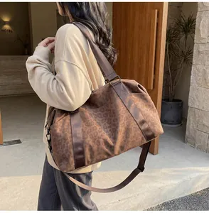 Detail view of large leopard print tote bag with adjustable shoulder strap and side pocket