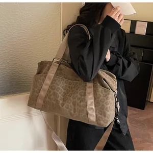 Detail of leopard print tote bag with side pockets and adjustable shoulder strap