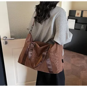 Detail of caramel leopard print tote bag with adjustable shoulder strap and large capacity