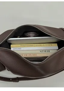 Top view of large brown leather tote bag showing spacious interior and golden zipper pocket